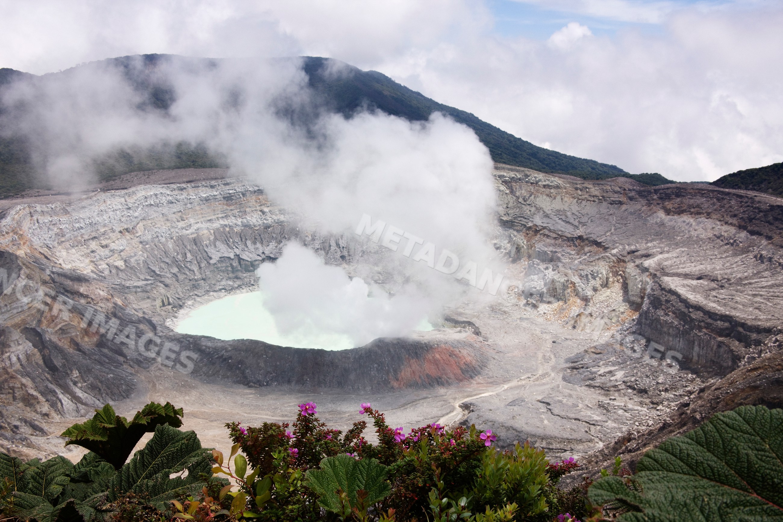 Poas volcano crater with steaming lake