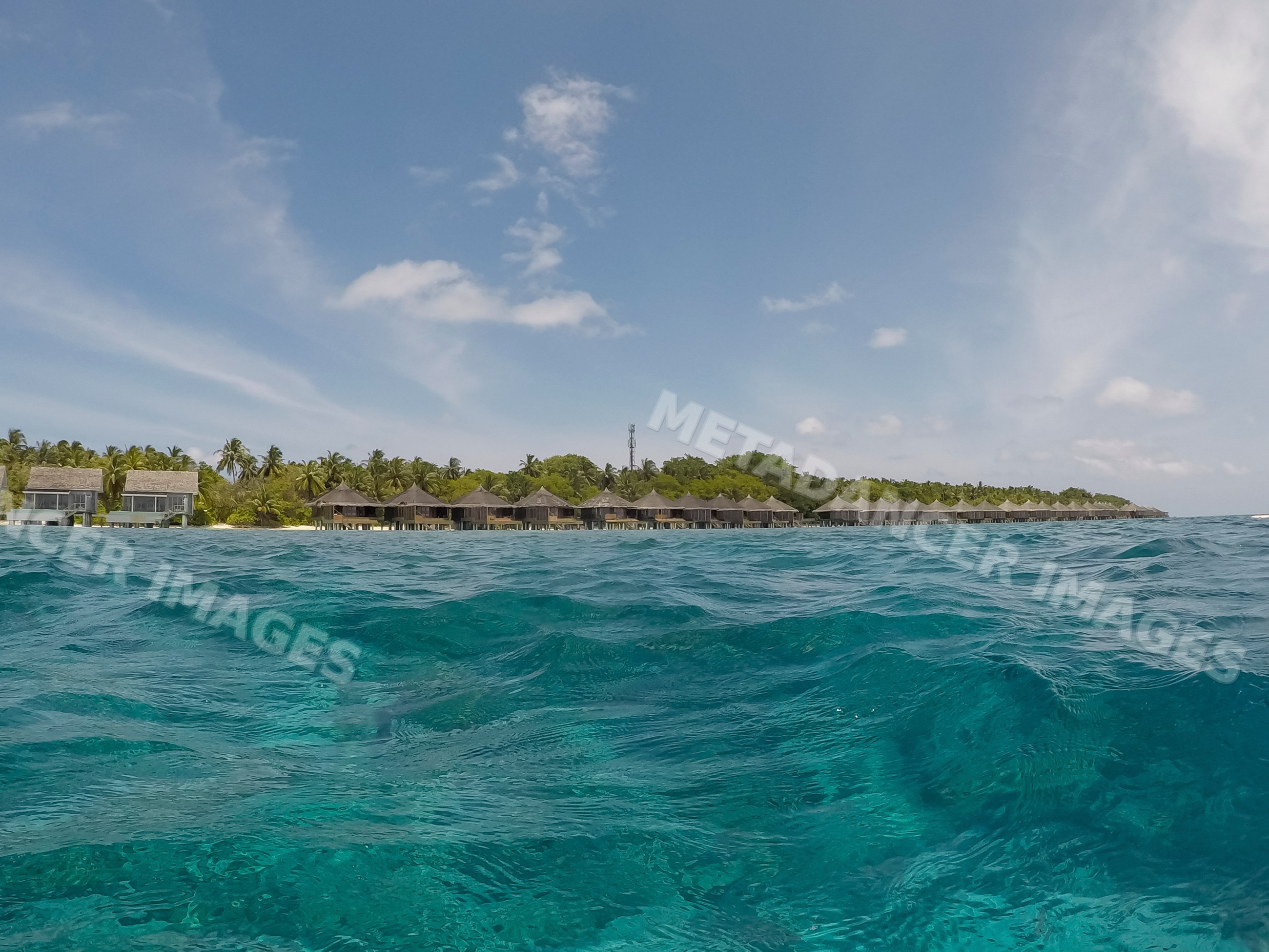 View of overwater bungalows on a tropical island