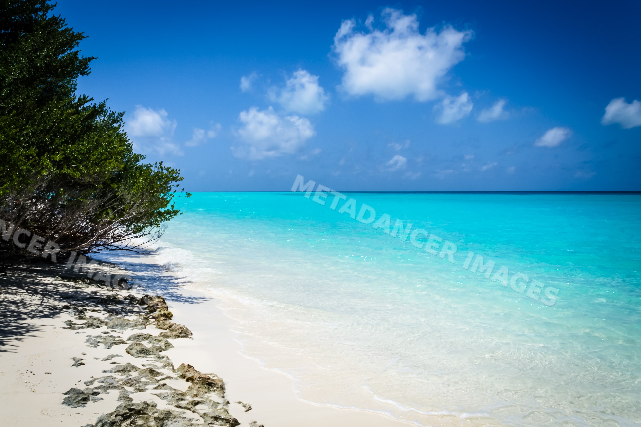 Beach with turquoise ocean water and white sand in a beach