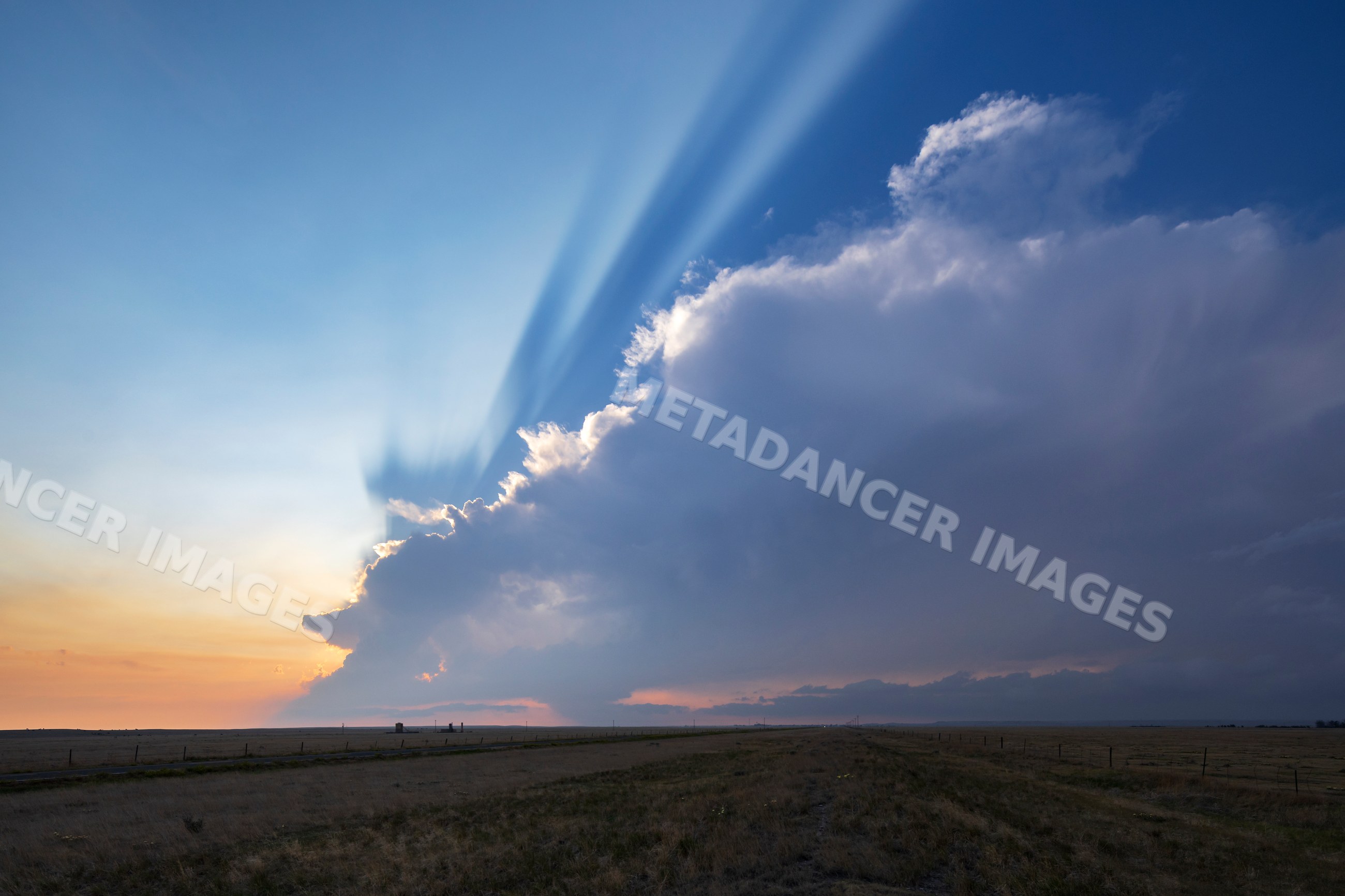 Storm cloud with crepuscular rays at Sunset in grover, colorado