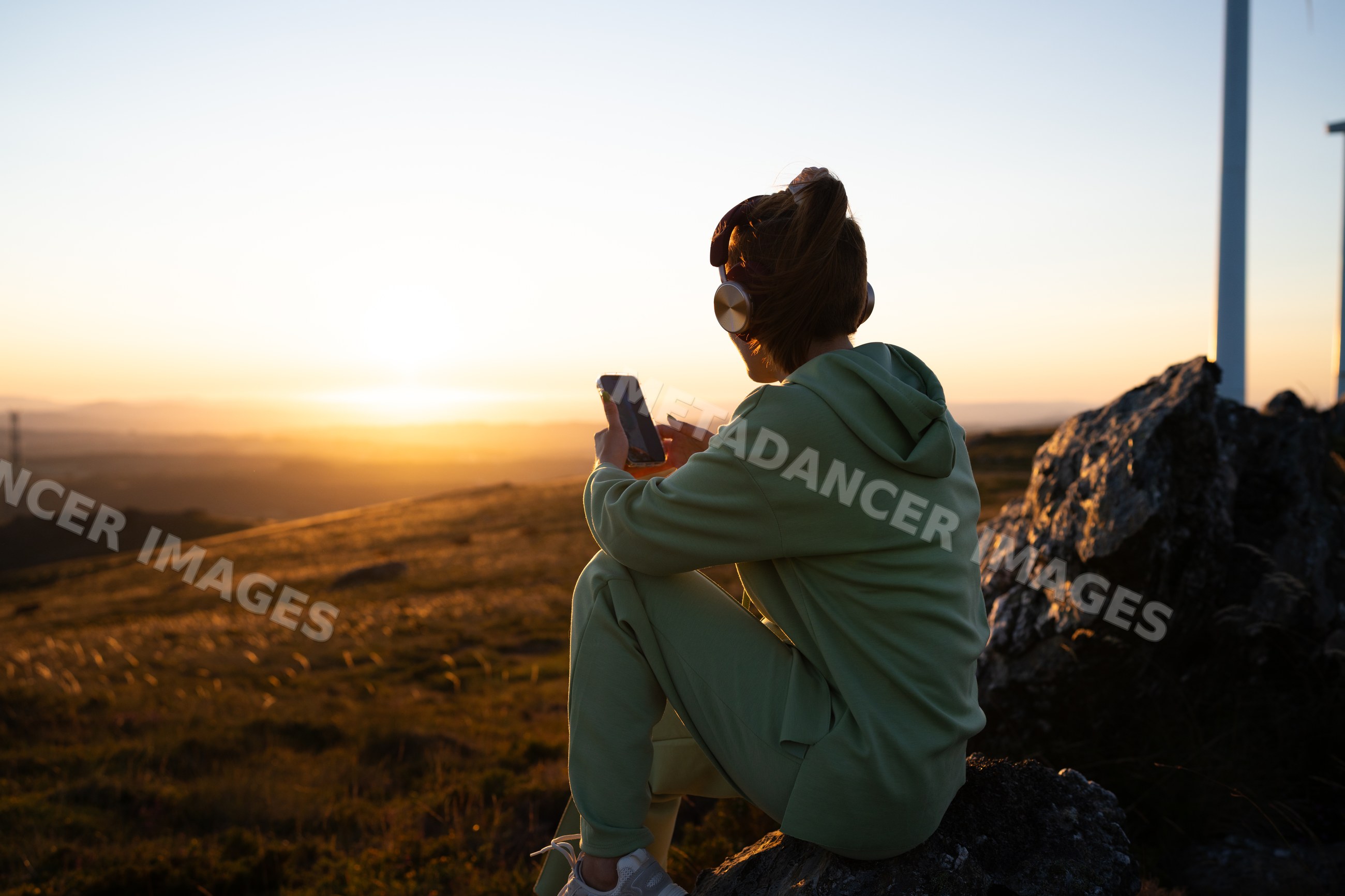 White Woman with headphones using smartphone outdoors