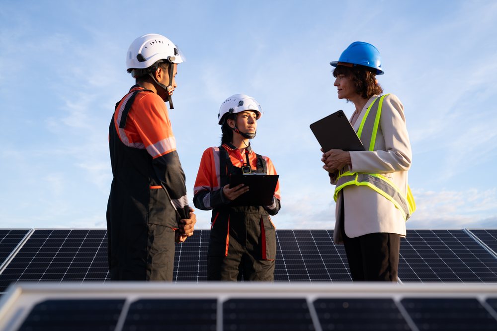 Engineers discussing solar panels outdoors