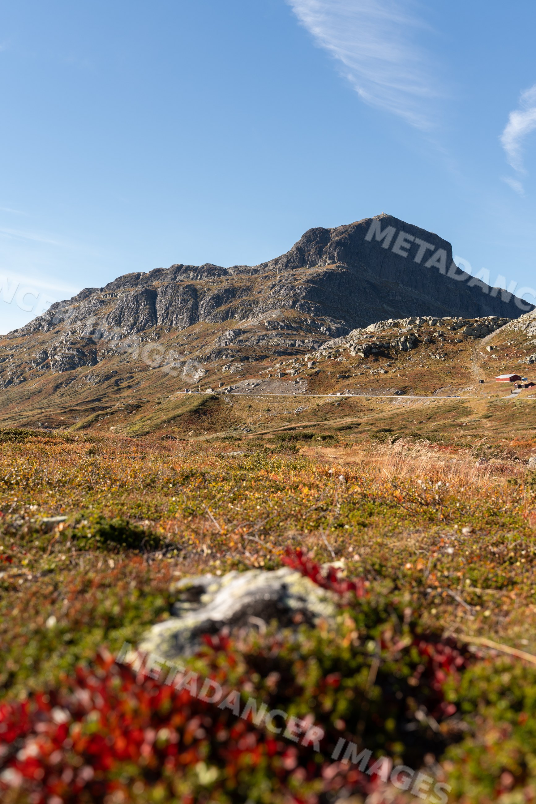 Rocky mountain and autumn vegetation with hiking trail