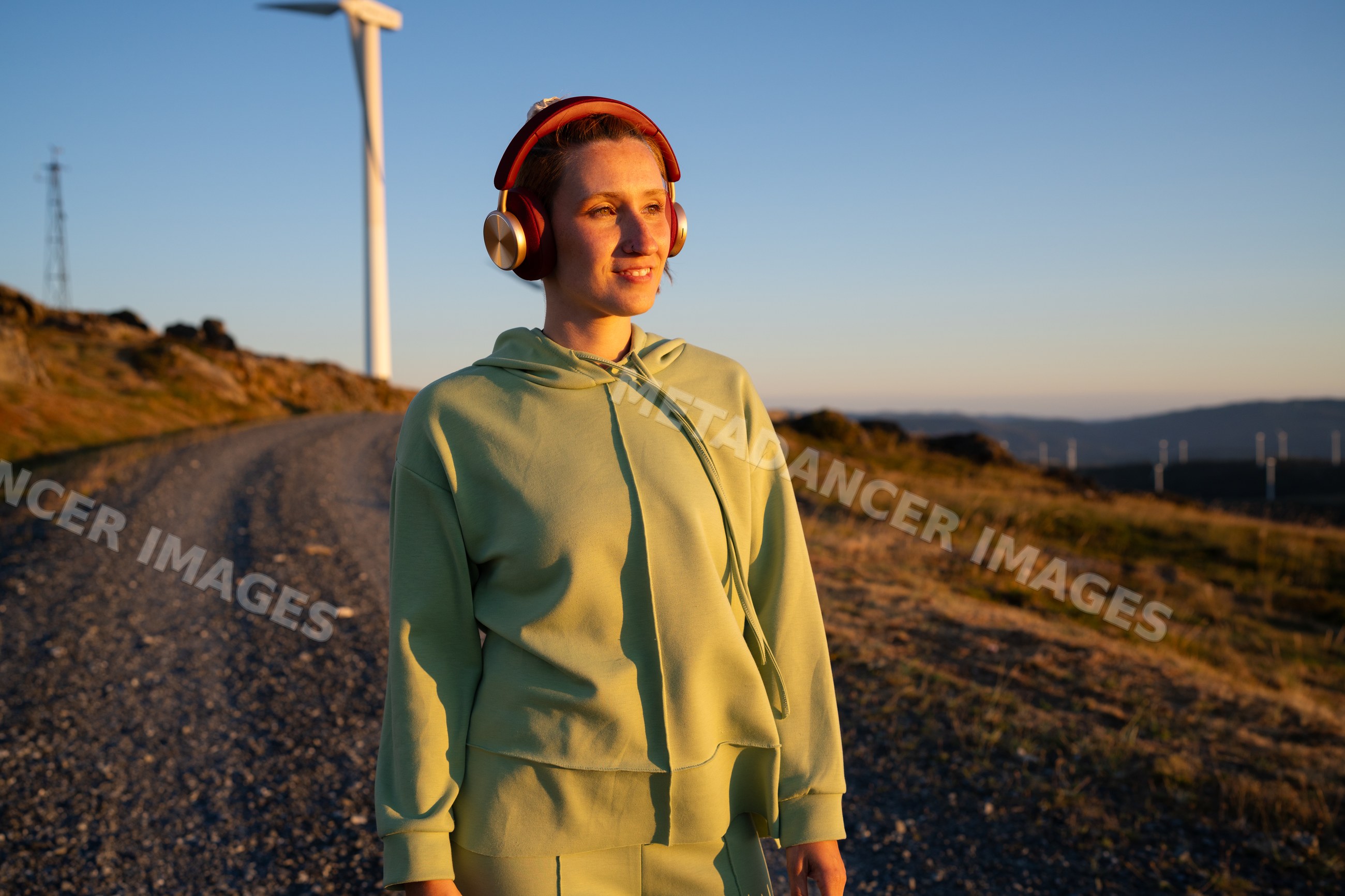 White Woman wearing headphones walking