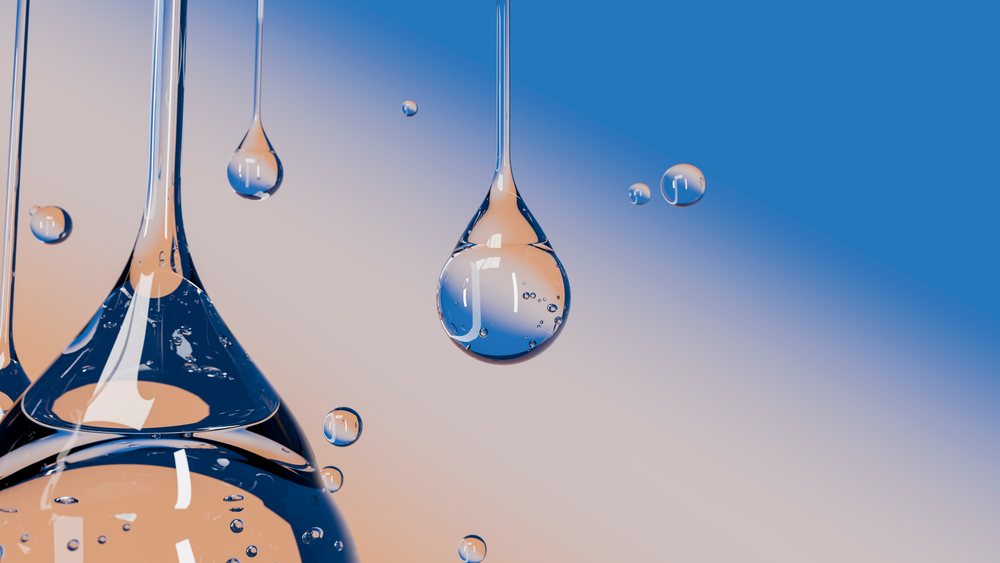 Close-up of transparent water droplets exhibiting surface tension