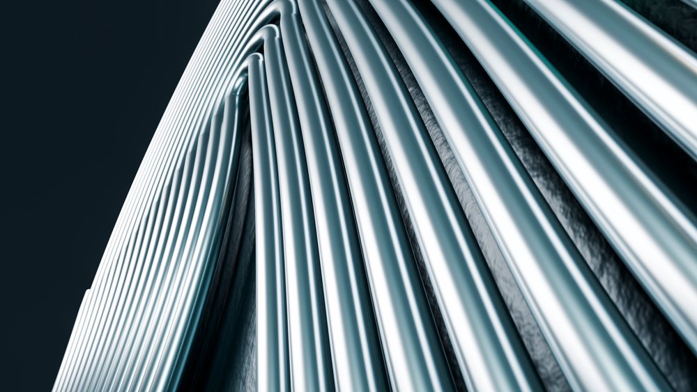 Vertical reflective metal tubes forming an abstract industrial pattern