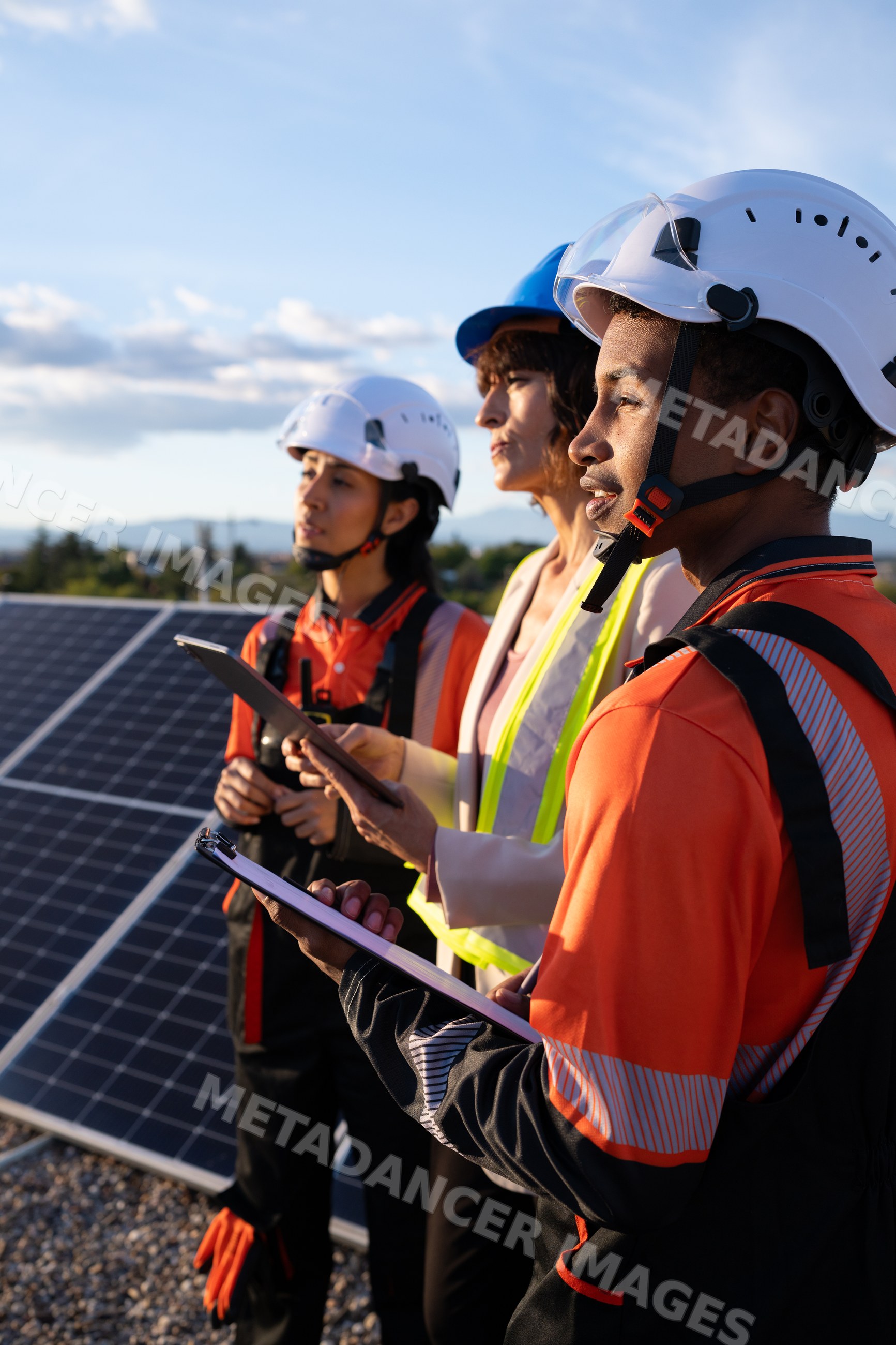 Engineers inspecting solar panels for renewable energy outdoors