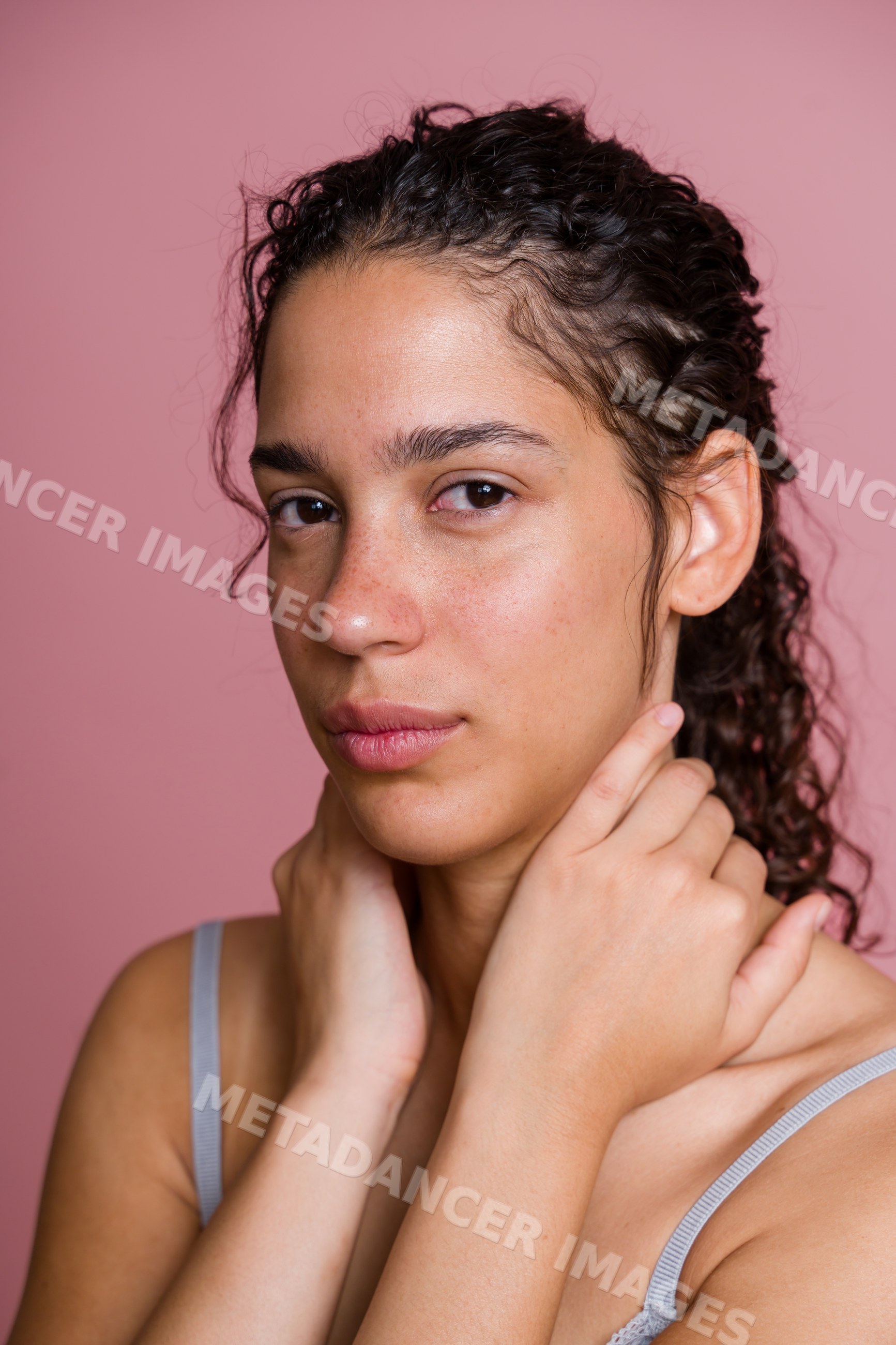 Portrait of Hispanic woman with curly hair and natural skin against