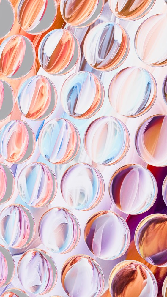 Colorful round glass marbles with abstract light reflections pattern