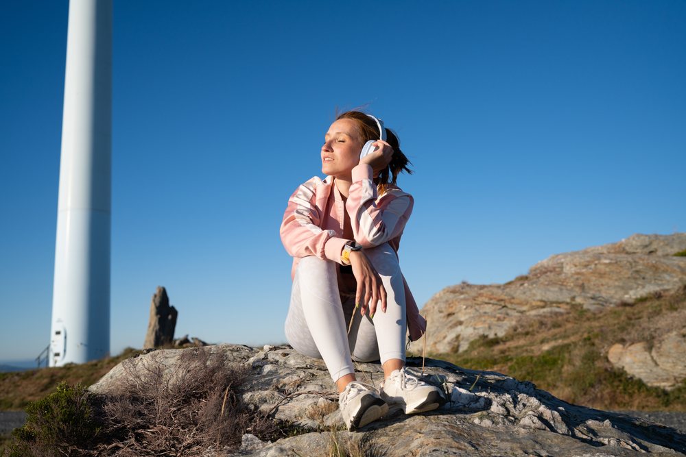 A young white woman listens to music