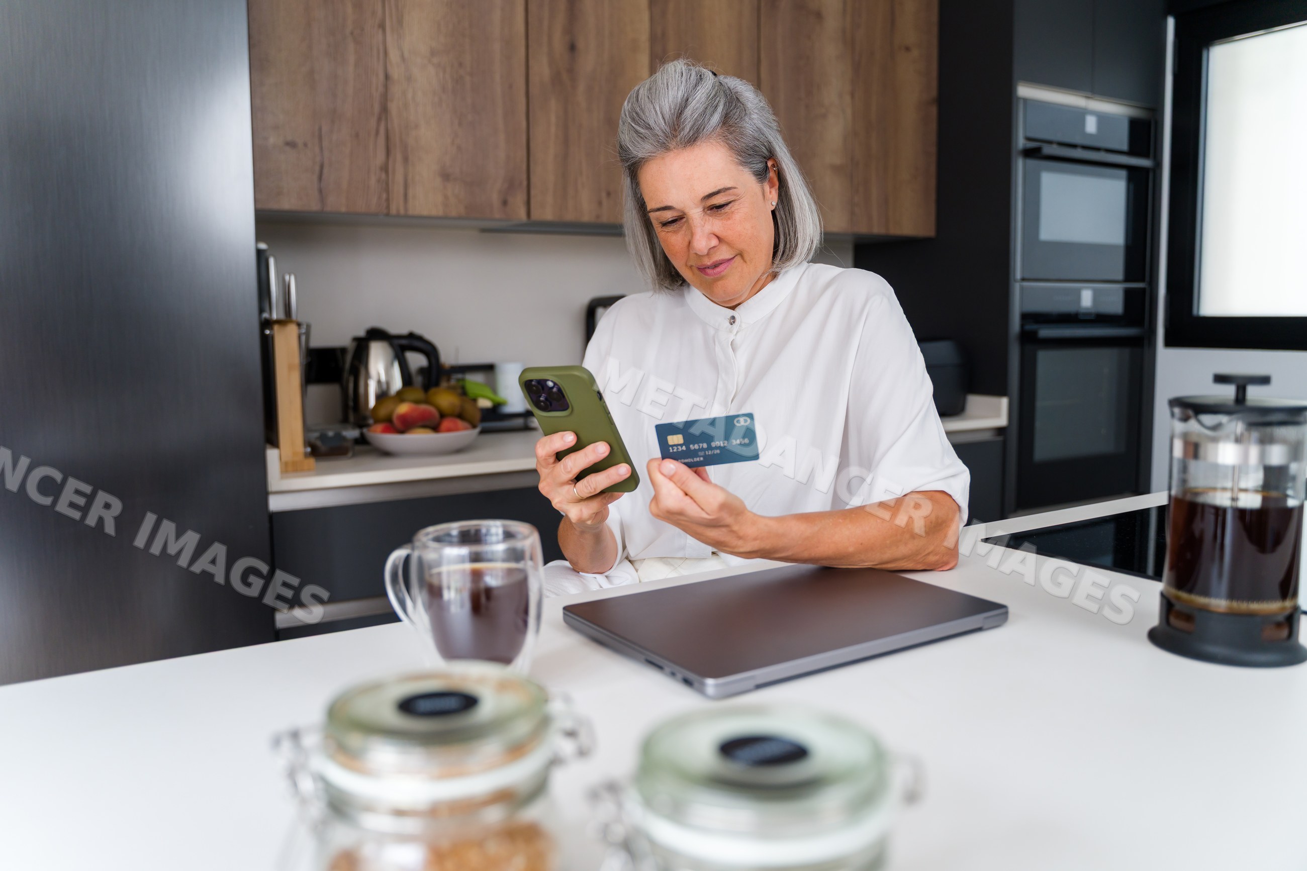 White Woman using smartphone and payment card for online shopping