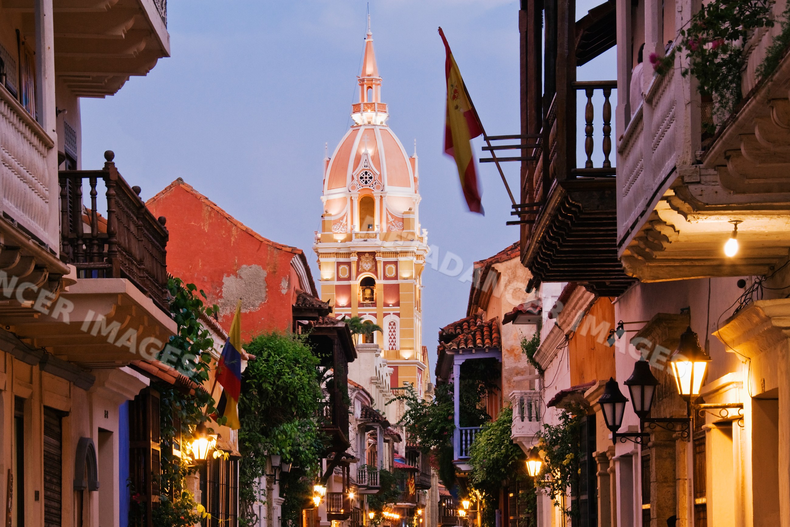 Cartagena cathedral tower in historic street scene at dusk, colombia