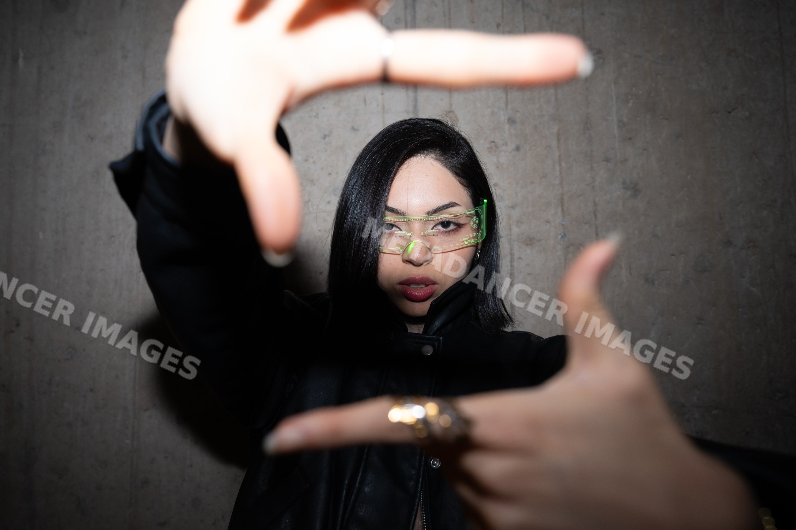 Hispanic woman posing with hands framing face wearing glasses