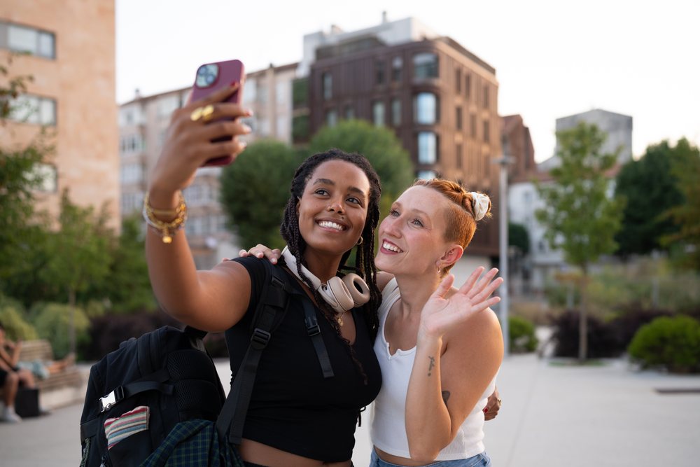 Two white and African American women taking a selfie together