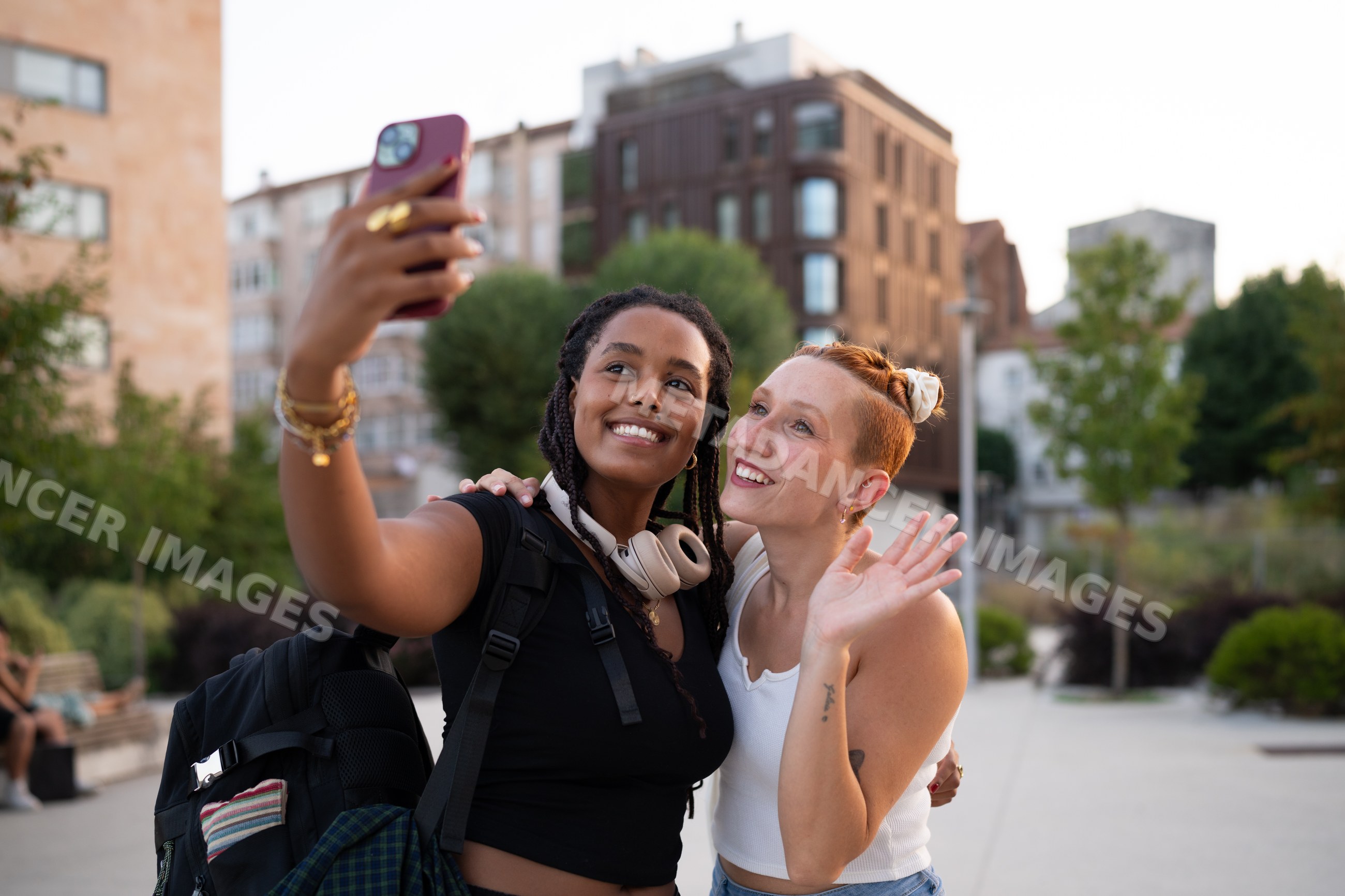 Two white and African American women taking a selfie together