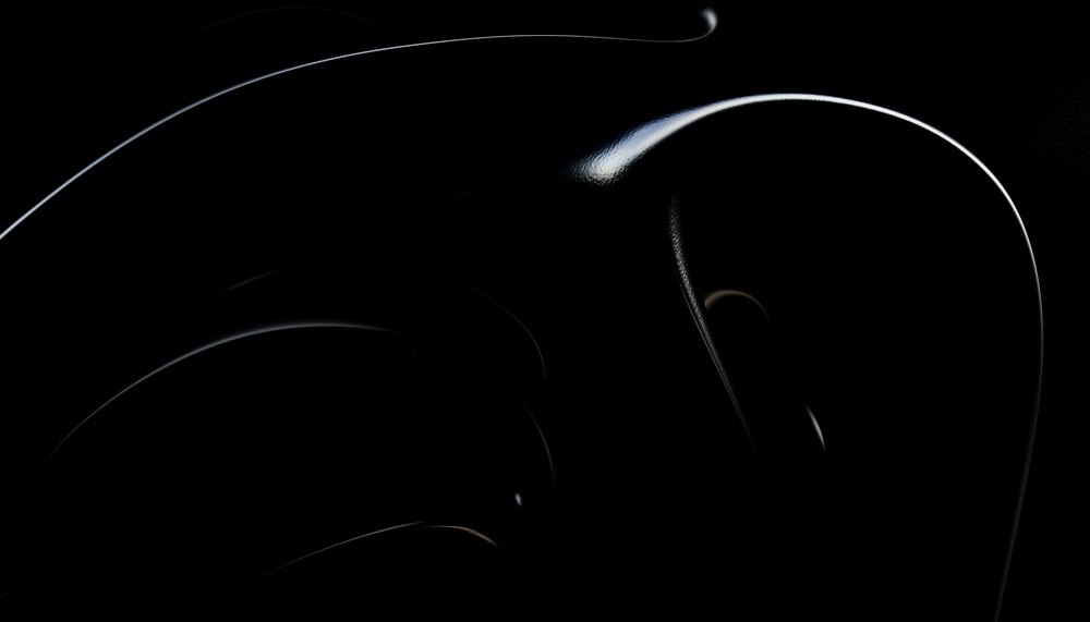 Close-up of a black abstract sculpture with glossy curved shapes