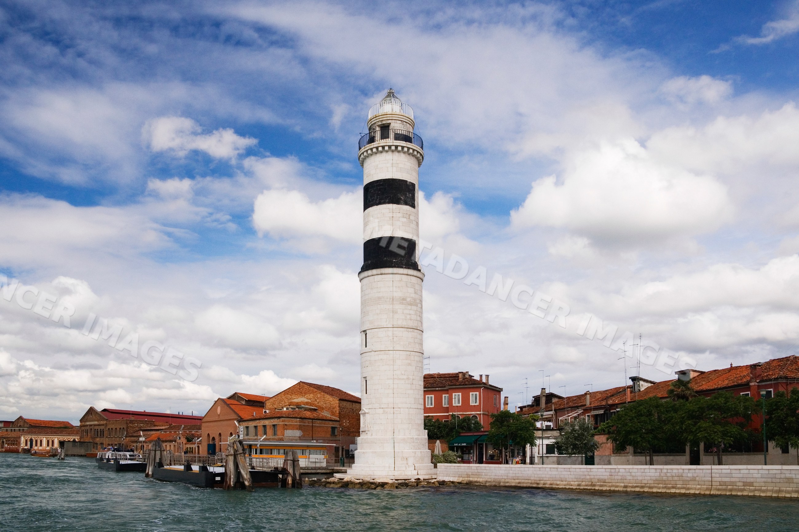 Lighthouse beside canal in murano venice italy
