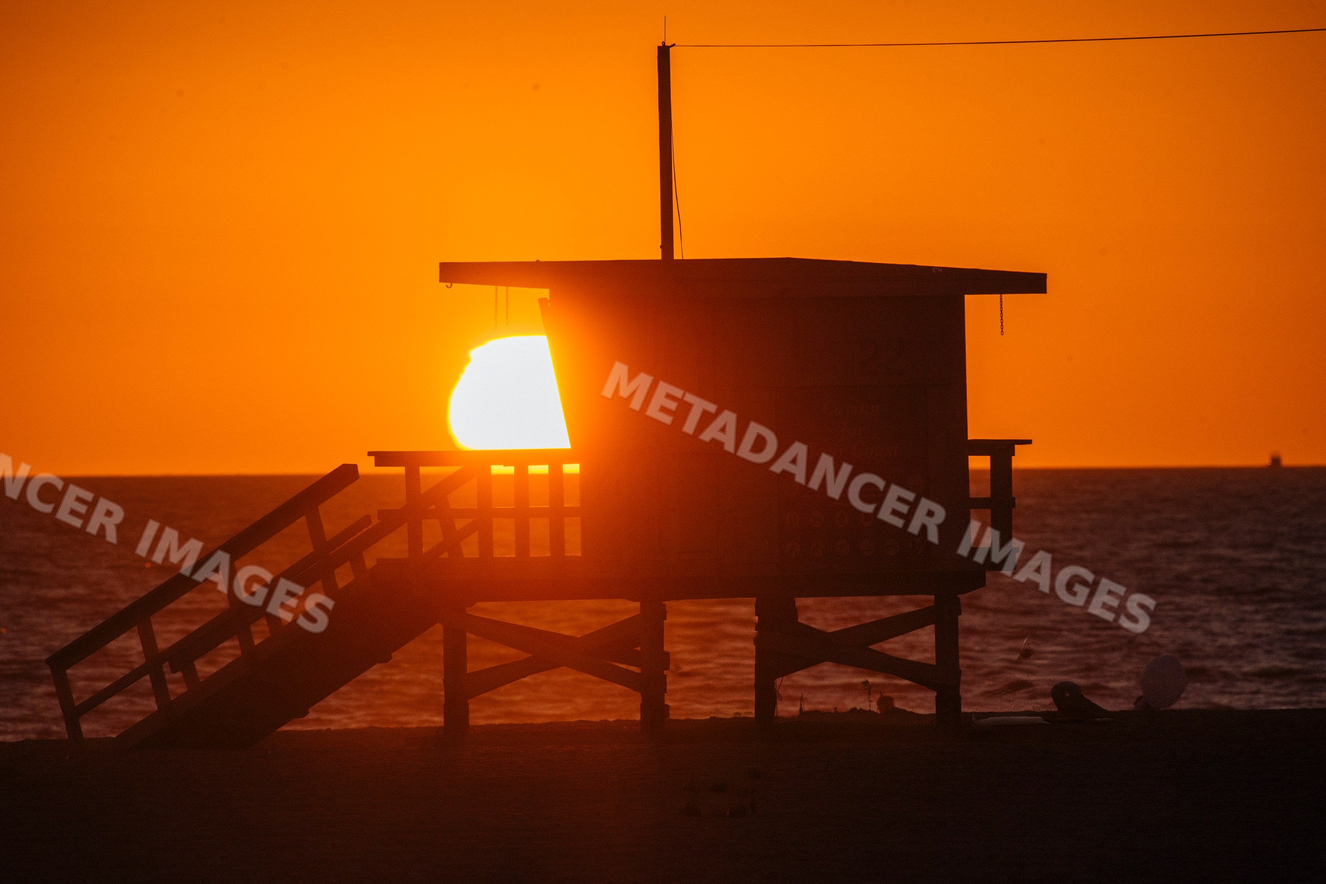 Sunset behind lifeguard tower on Santa Monica beach