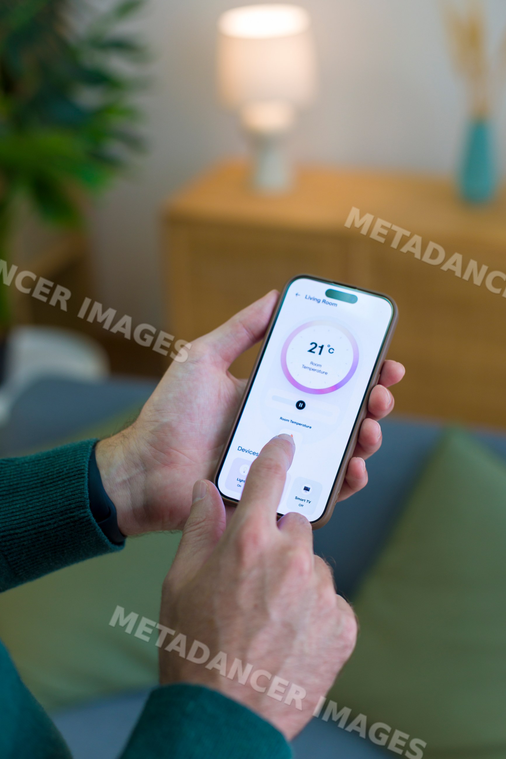 White person adjusting room temperature with smartphone