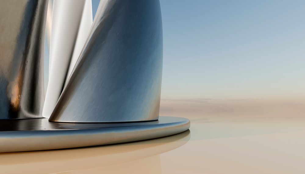 Close-up of a reflective curved metal sculpture with smooth shiny