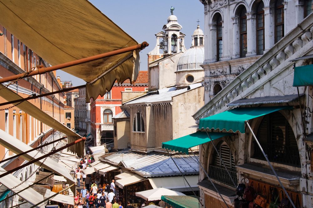 Rialto market street bustling with tourists and shoppers in venice