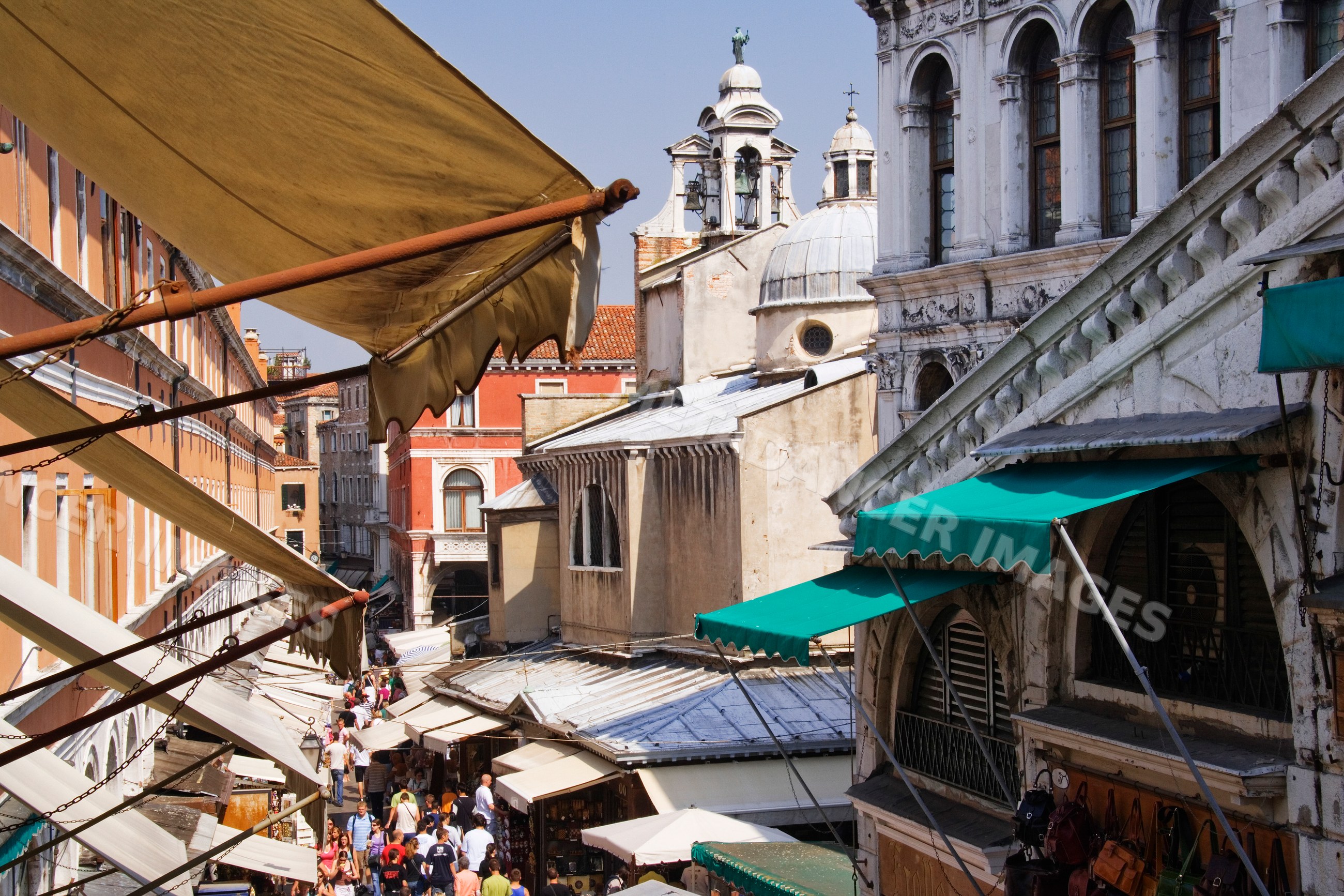 Rialto market street bustling with tourists and shoppers in venice