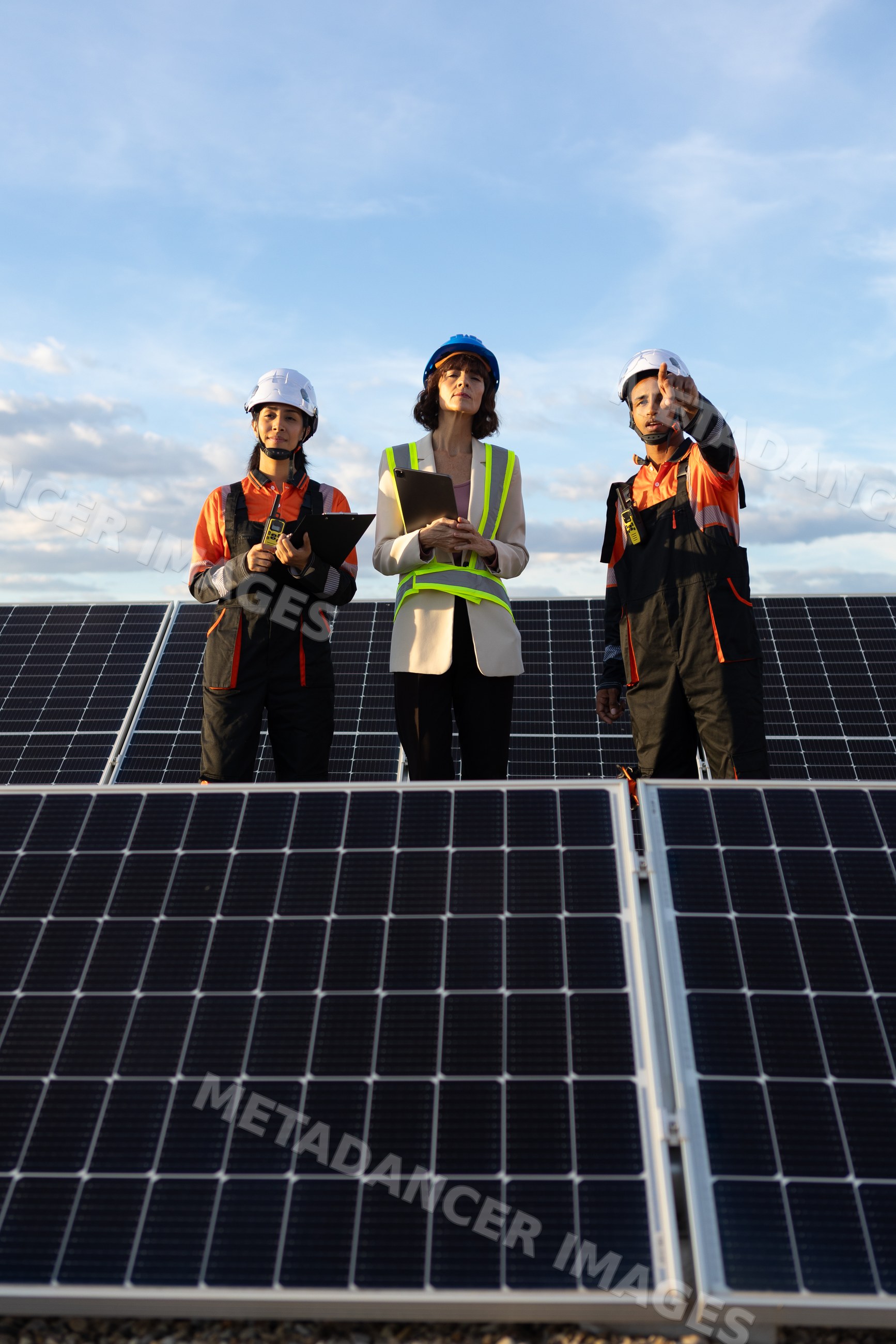 Engineers inspecting solar panels for renewable solar energy