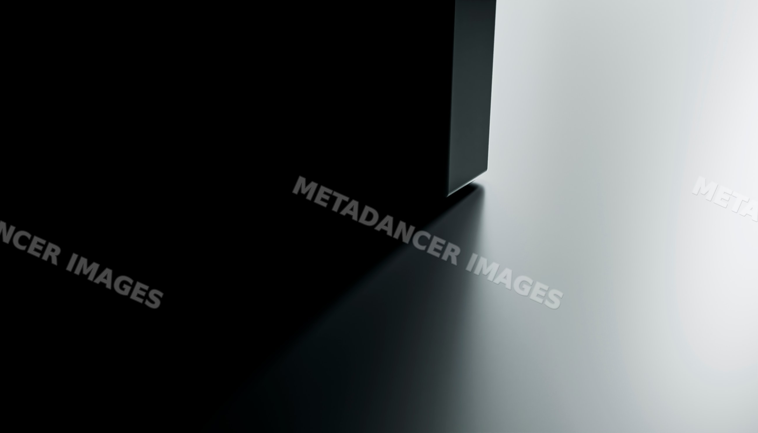 Shadow cast by black rectangular object on white surface