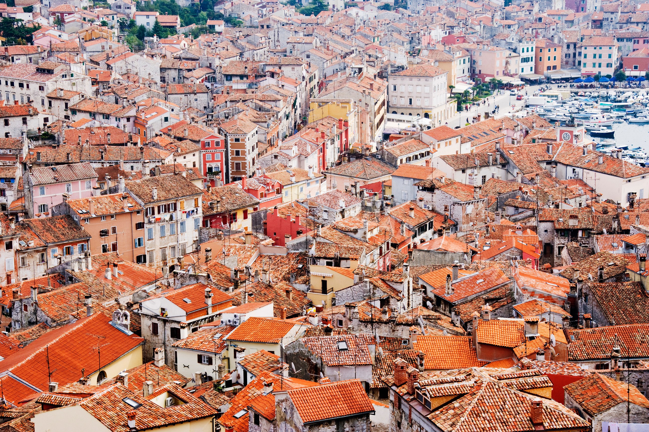 Aerial view of rovinj town with red tiled rooftops and harbor