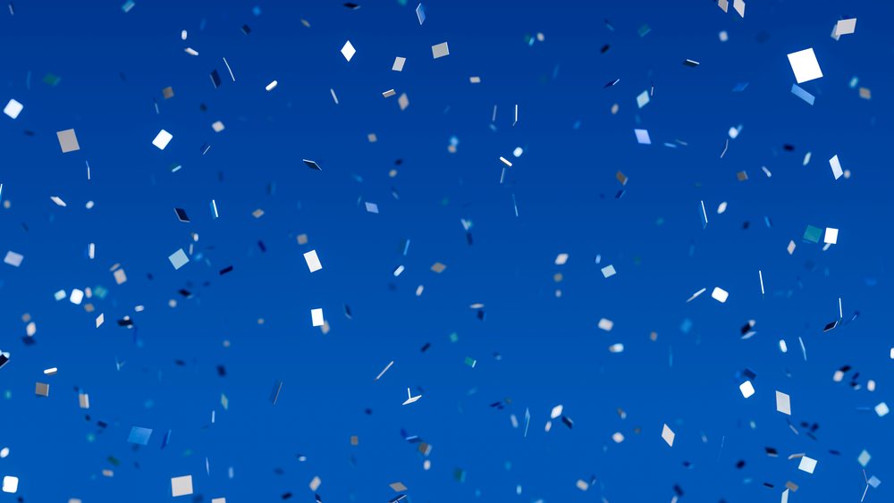 Colorful confetti scattered on a vibrant blue background