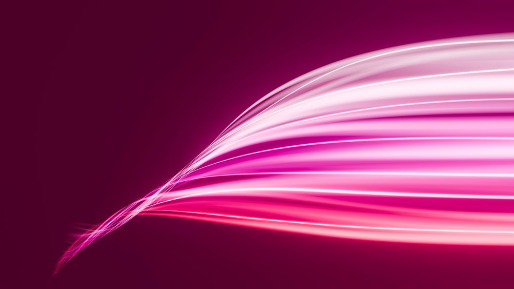 Abstract pink glowing light trails flowing