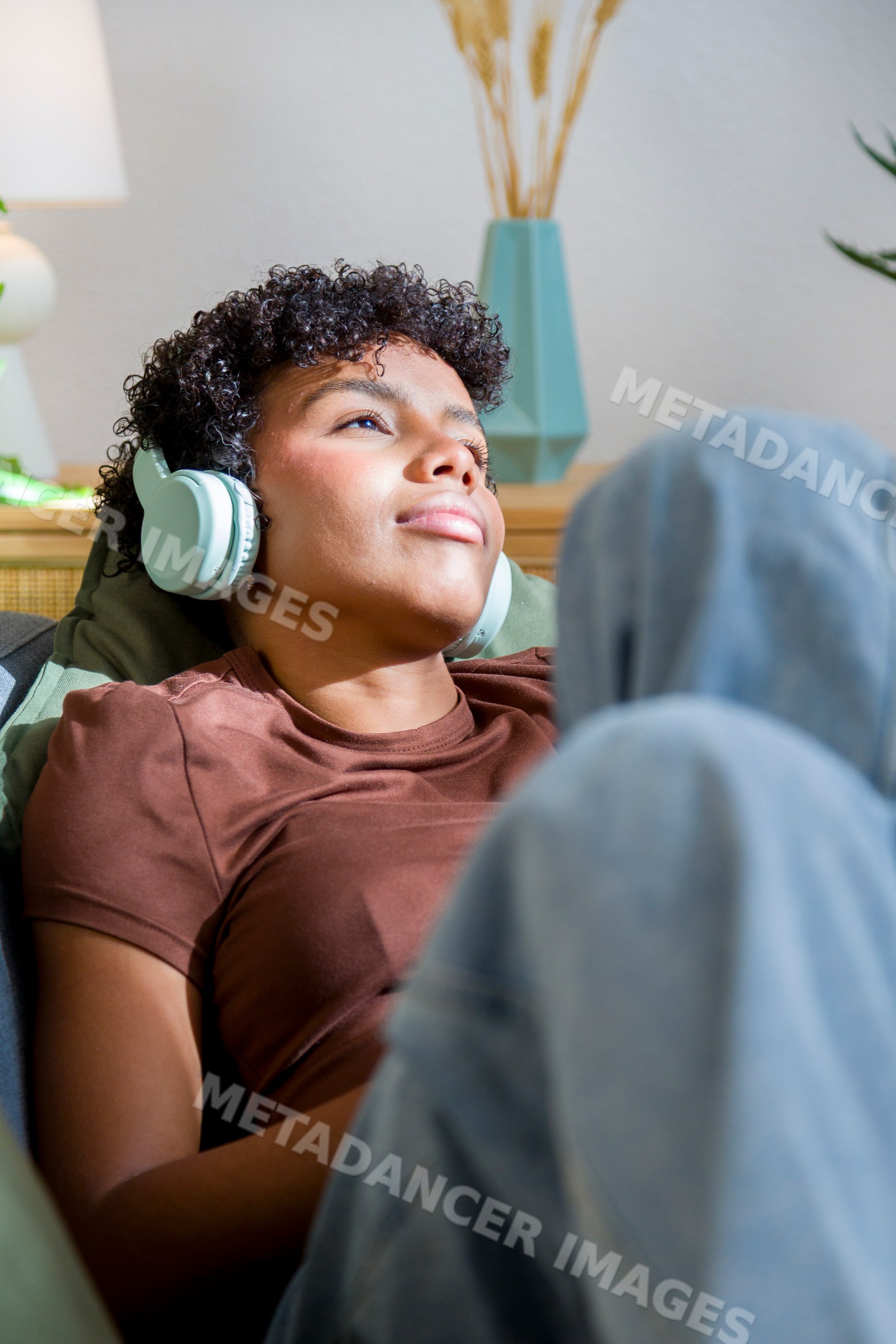 Young African American woman relaxing and listening to music