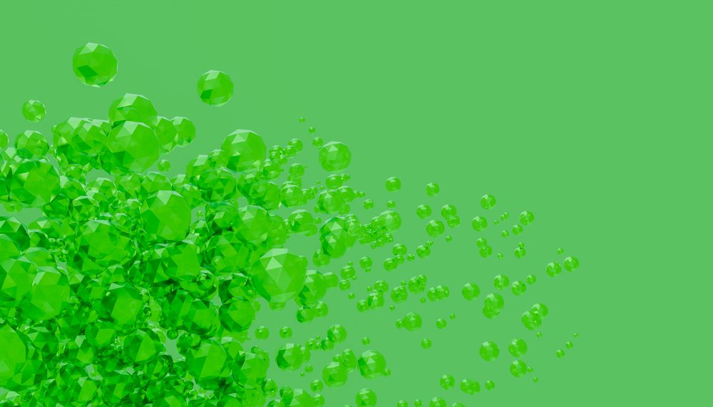 Cluster of green translucent geometric spheres on green background