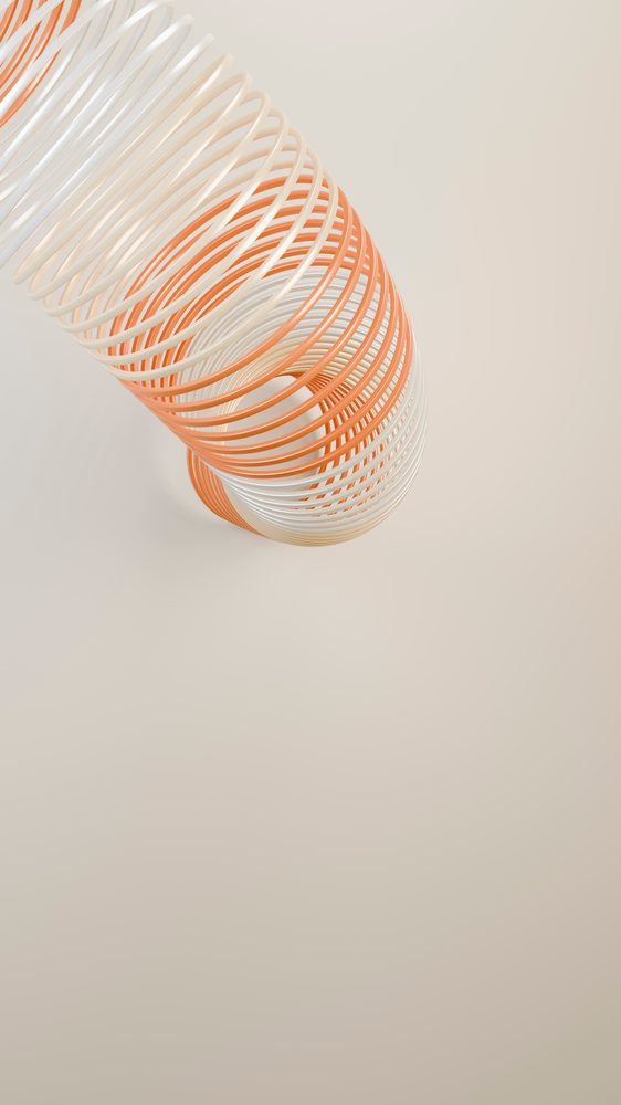 Slinky toy with orange and white coils from upward angle