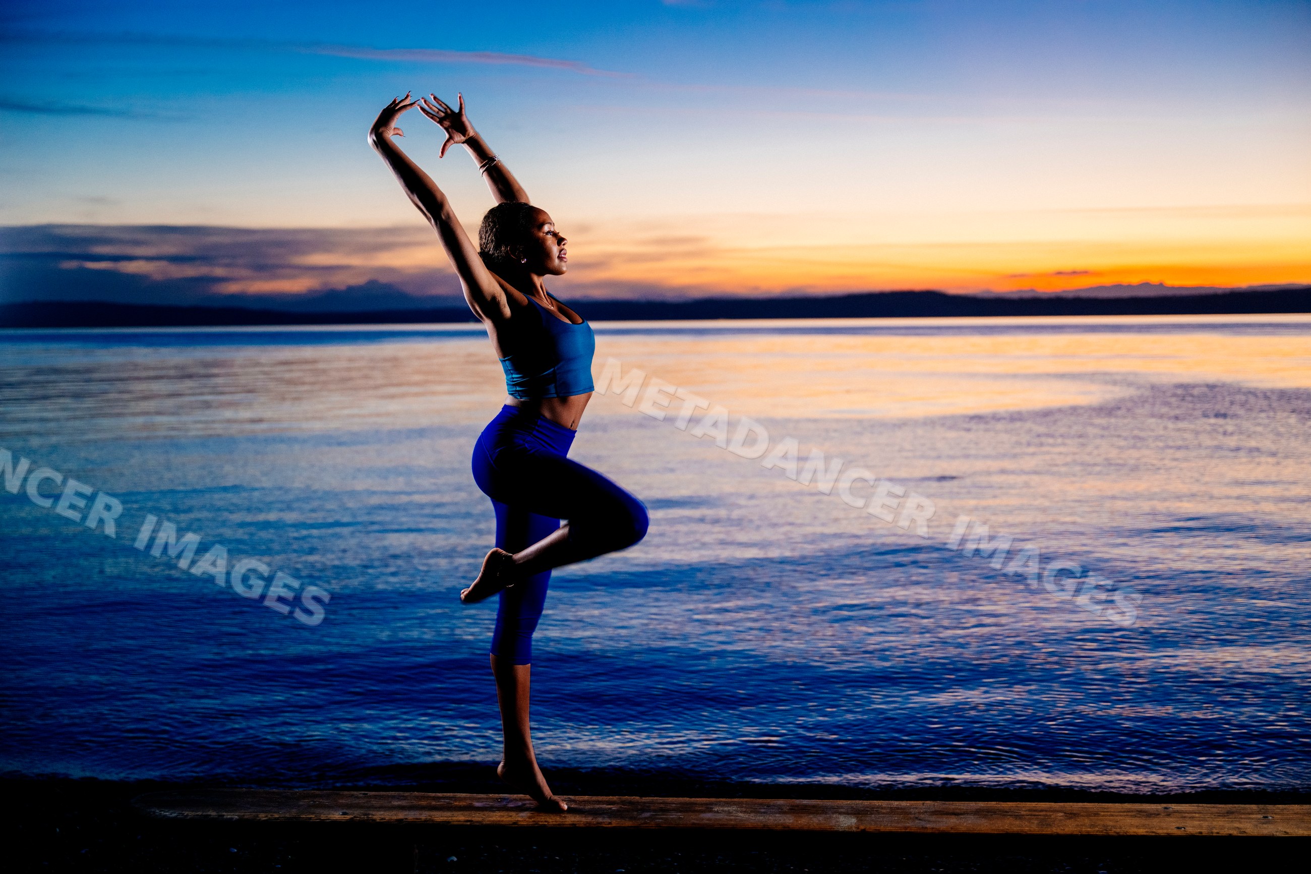 Hispanic woman practicing a yoga balancing pose