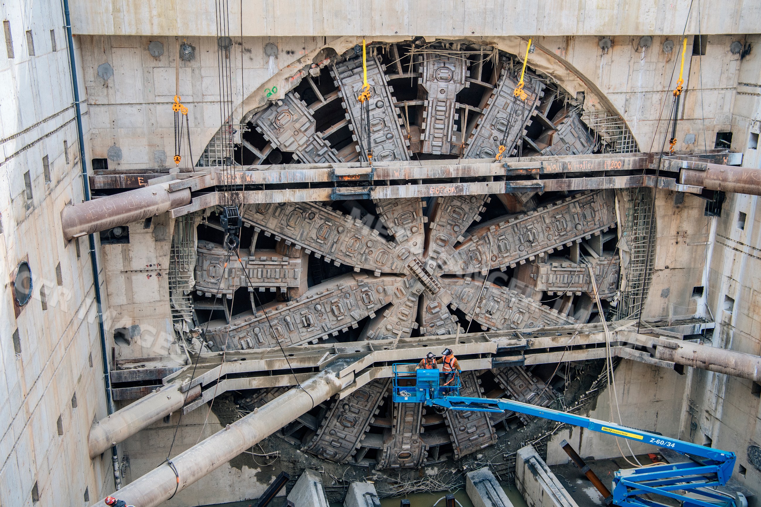 Construction white workers operate tunnel boring machine
