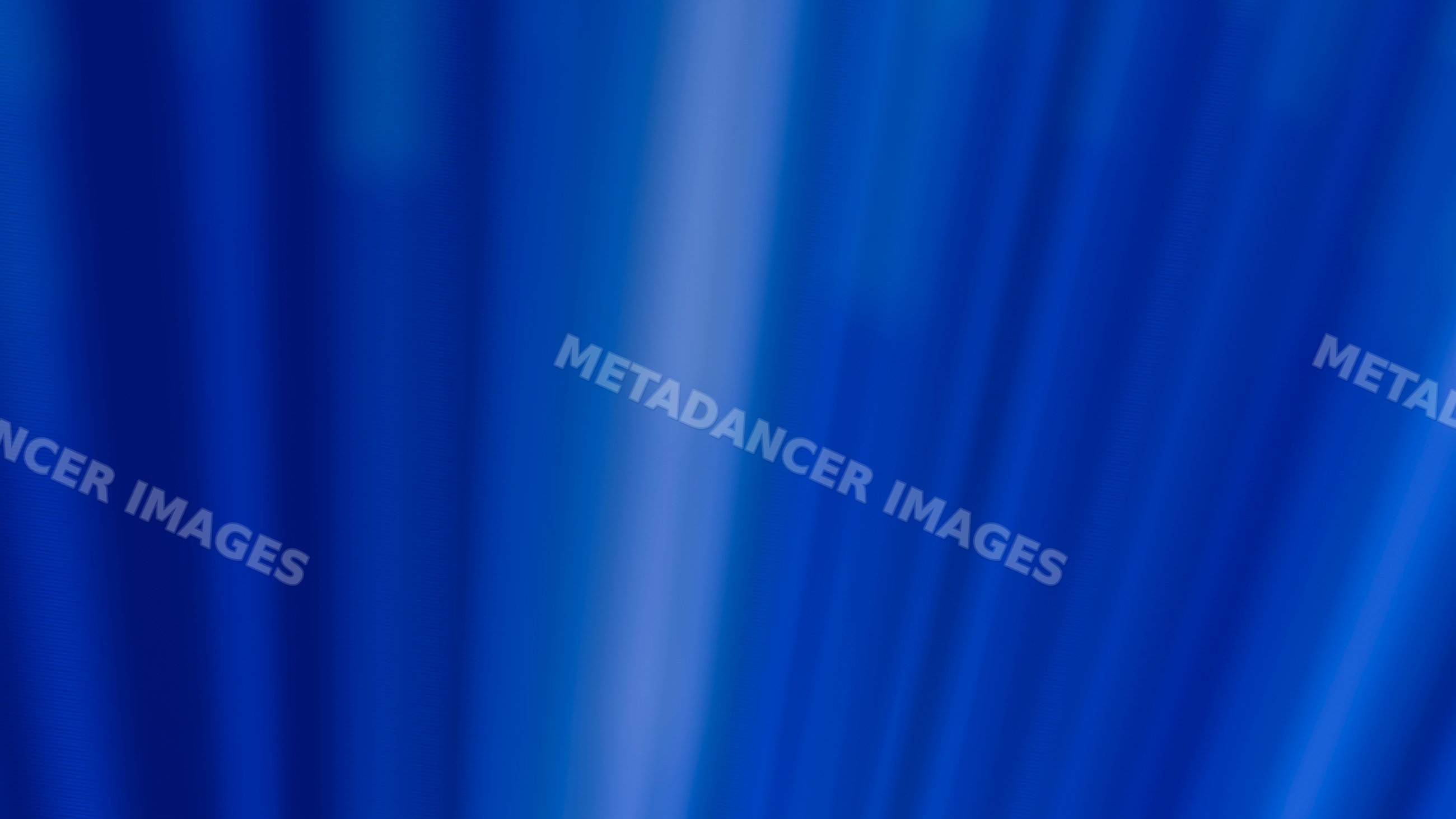 Blue fabric with soft flowing folds and smooth texture