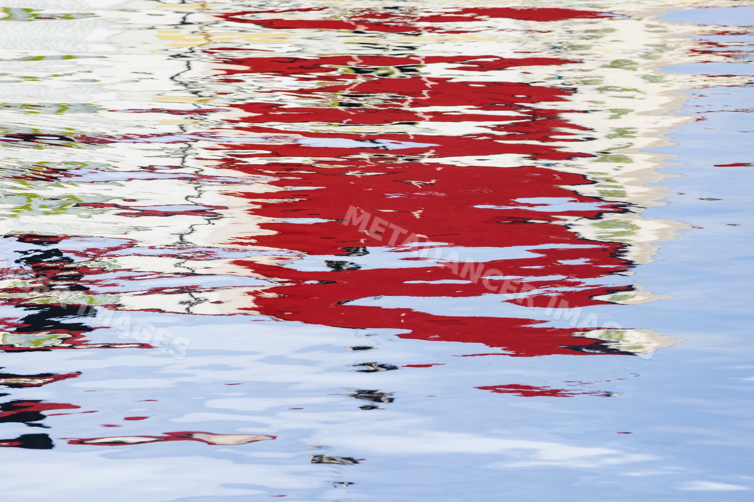Reflection of colorful buildings on water in Henningsvaer, Norway