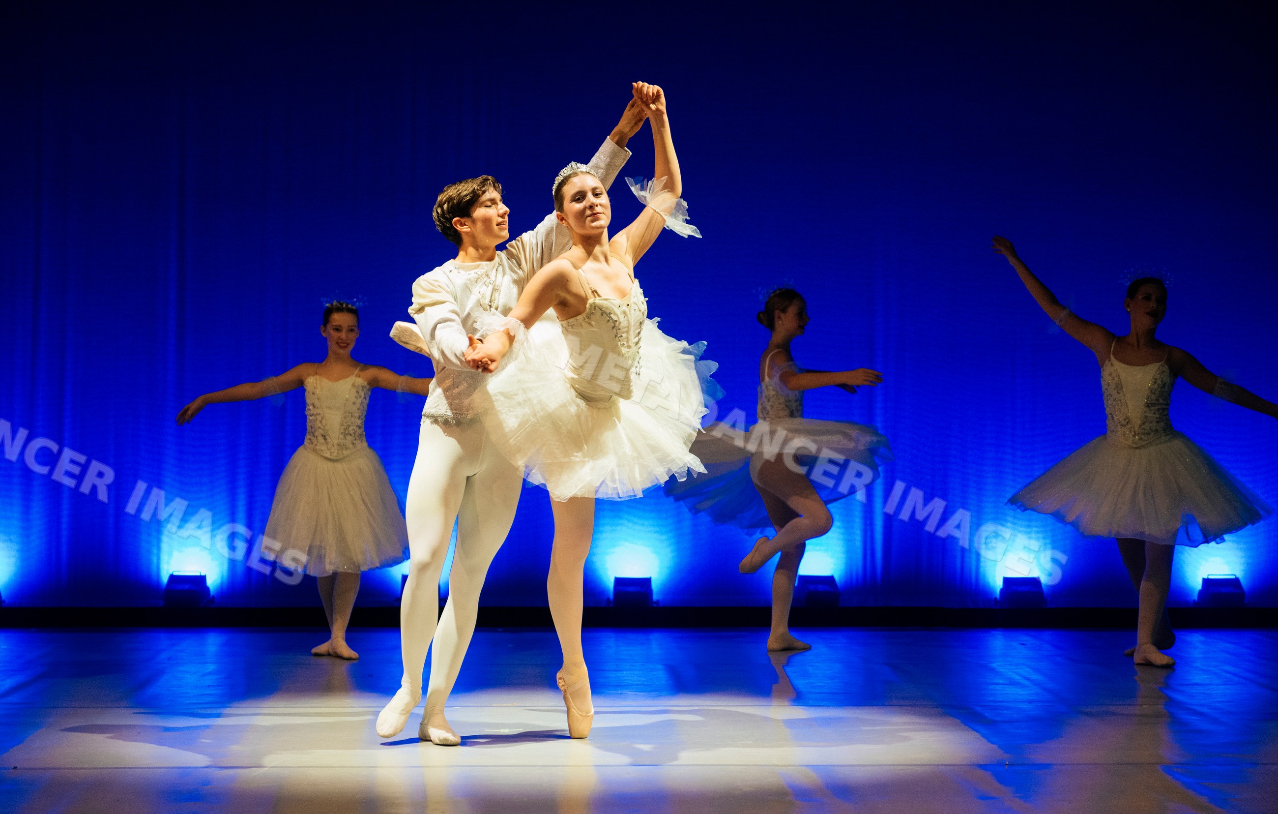 Ballet dancers perform a classical routine on stage during a ballet