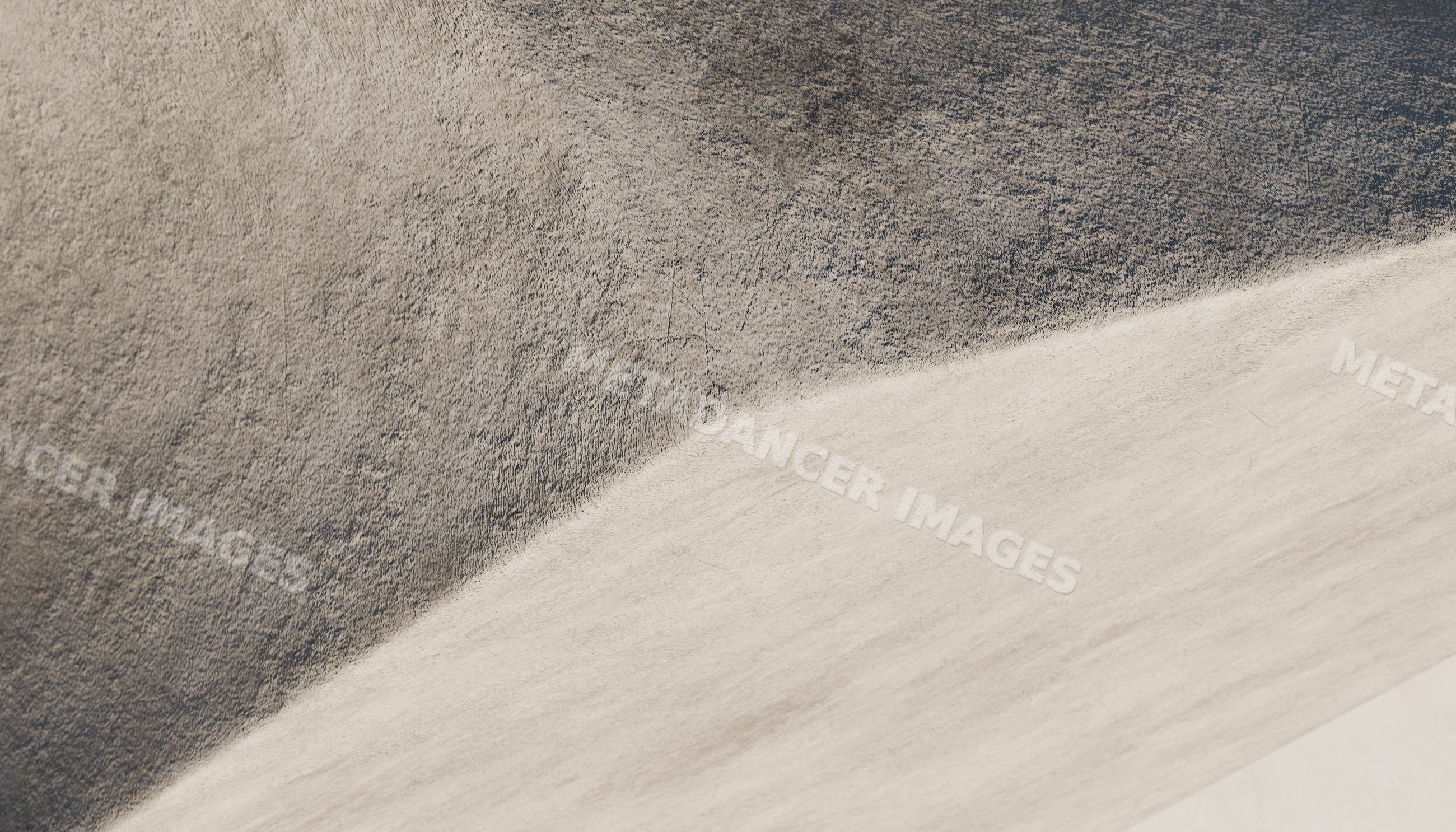 Close-up of a textured light and dark gray concrete wall surface