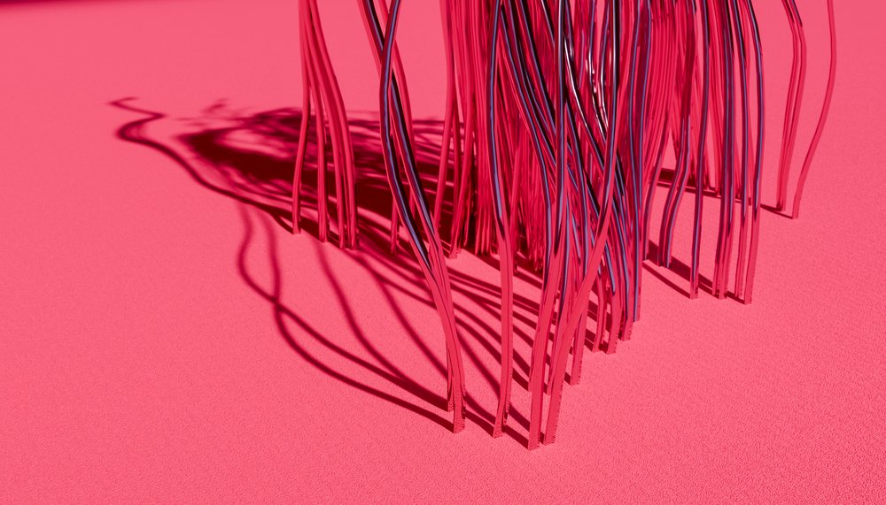 Abstract reflective metal sculpture casting shadows on a pink