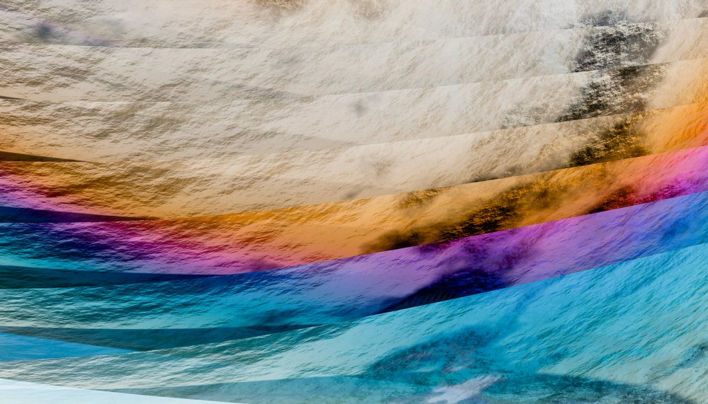 Vibrant abstract waves creating colorful reflections on textured water