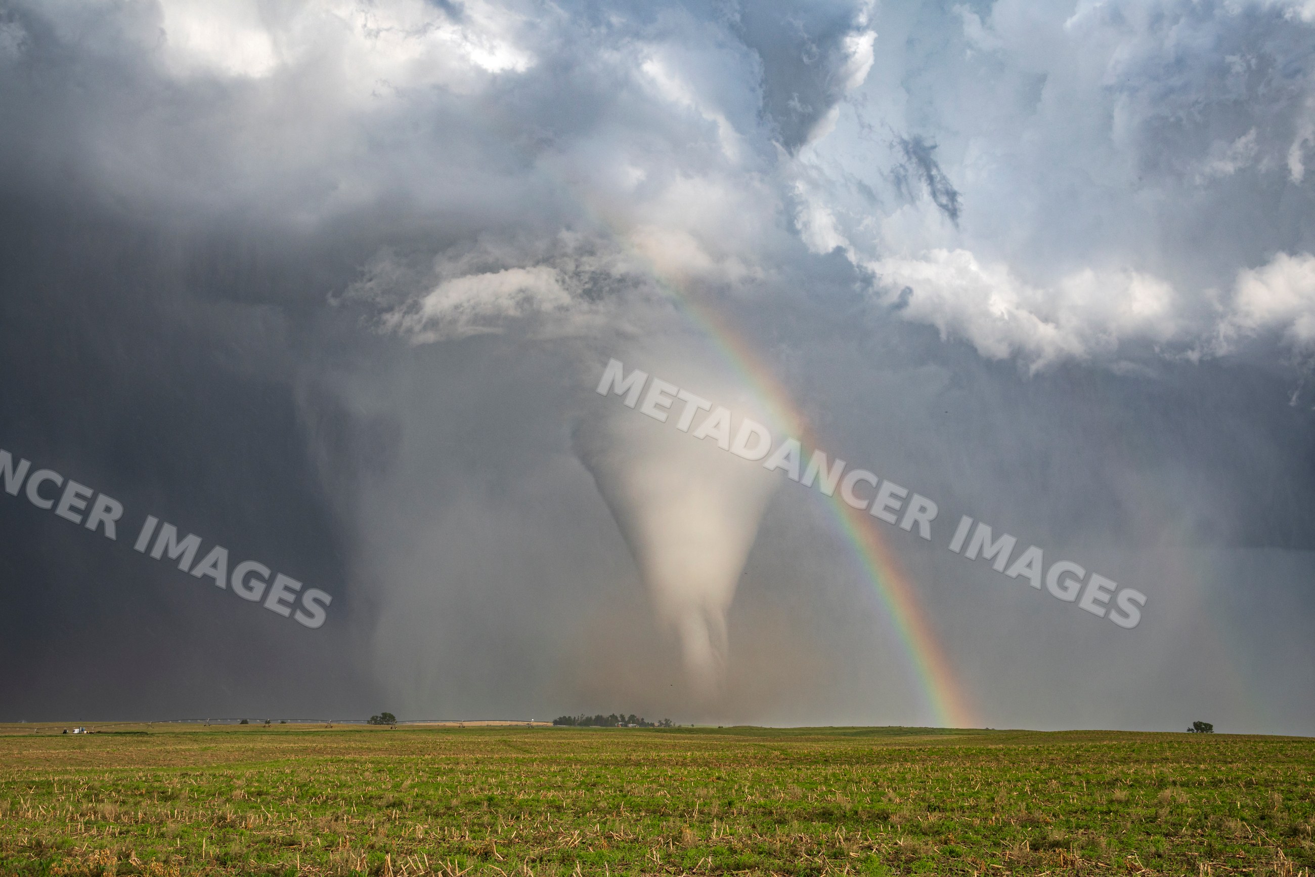 Tornado with Rainbow over field in dickens, nebraska, USA
