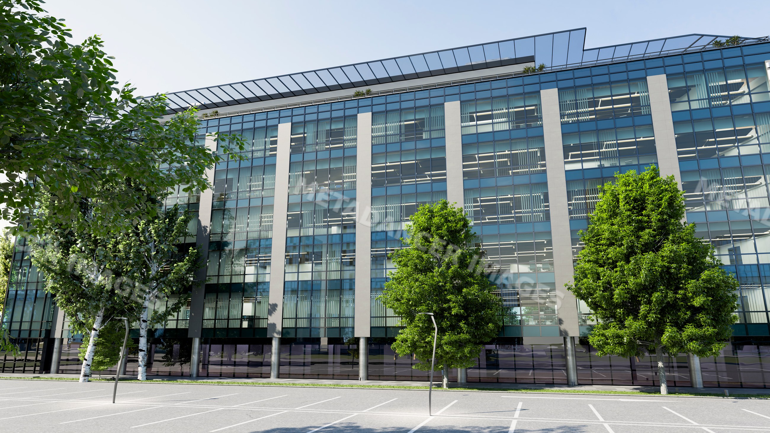 Modern office building with glass facade and trees in front