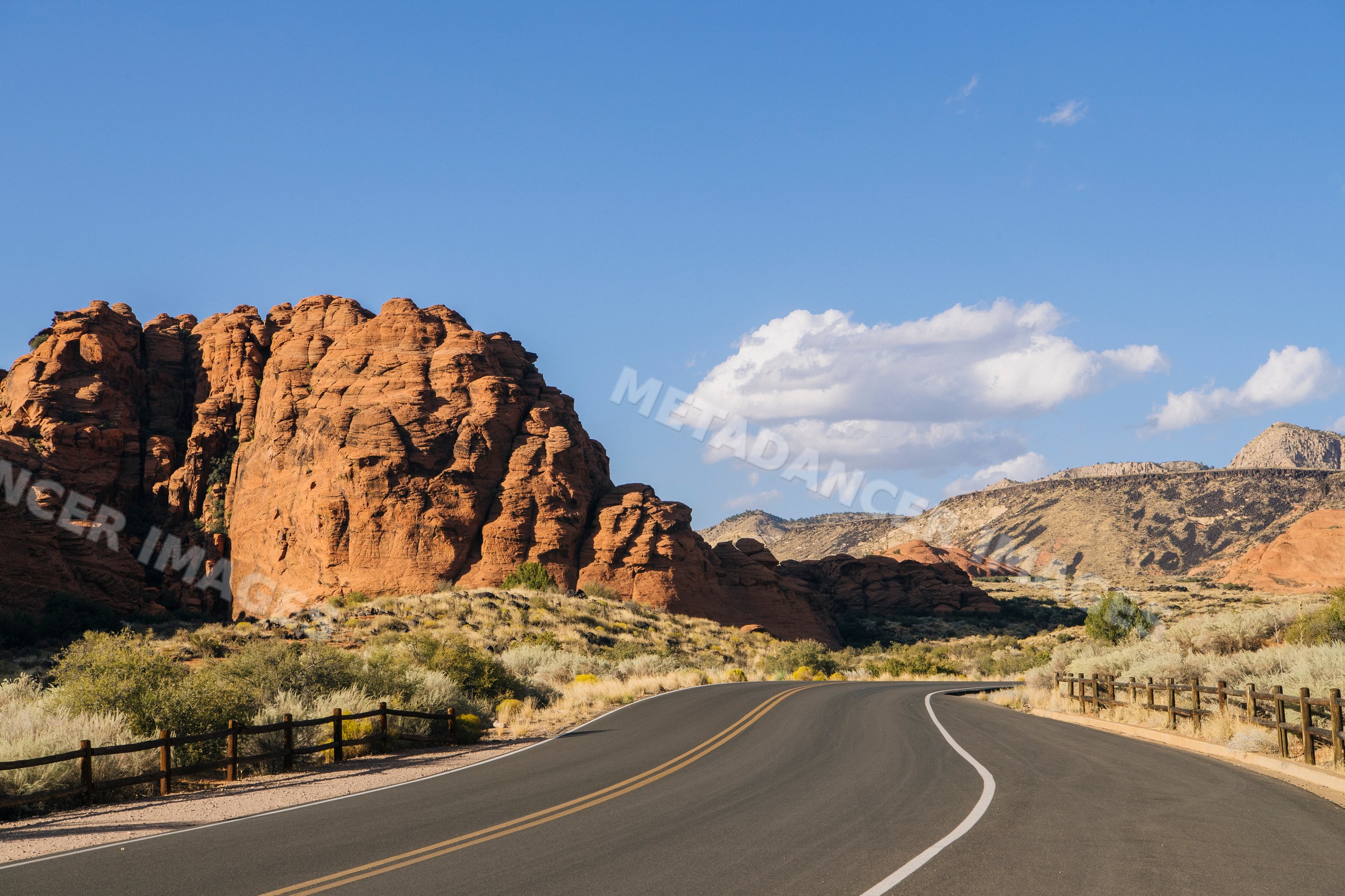 Curved road along red cliffs in Utah's red Cliffs Desert State Park