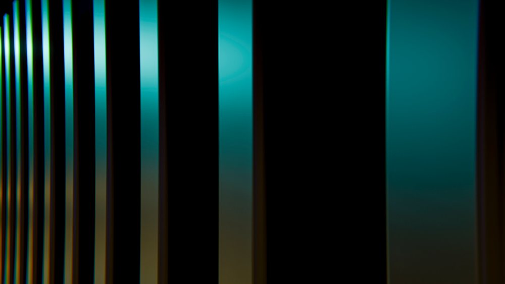 Abstract vertical black bars with blue and yellow light reflections