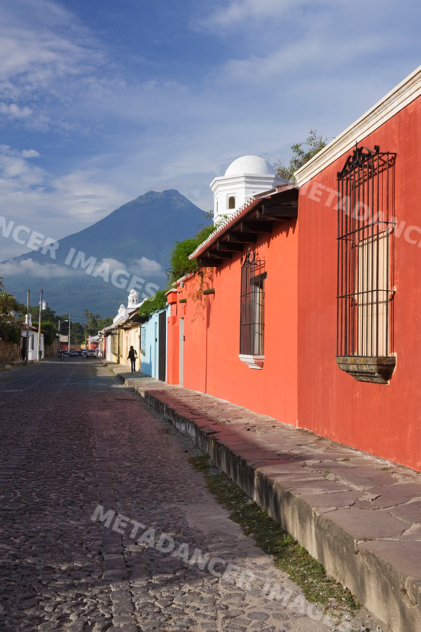 Street with colorful houses and volcano guatemala