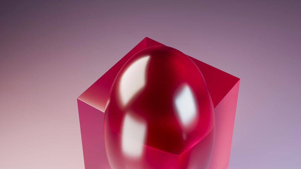 Red glossy egg sculpture on red cube with pink gradient background
