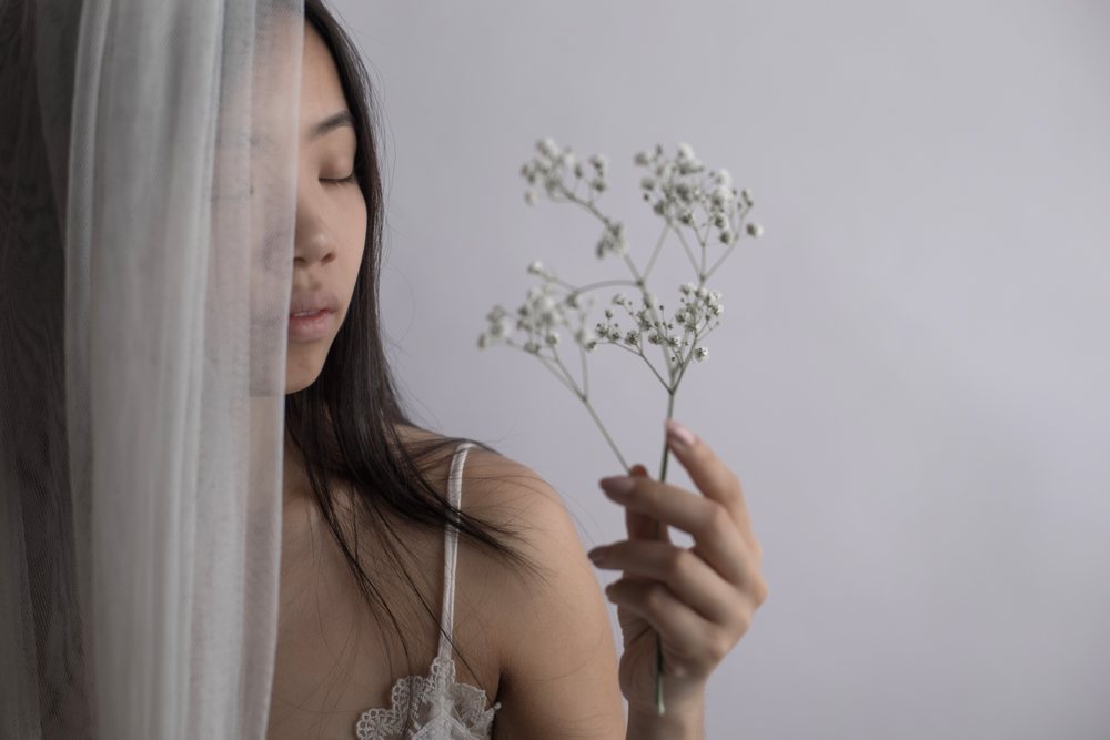 Portrait of Southeast Asian woman holding baby's breath flower