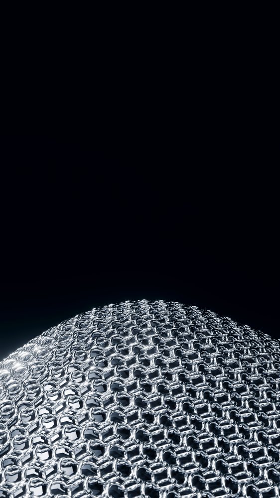 Close-up of shiny silver chainmail armor with black background